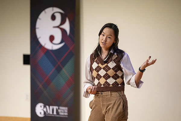 A woman presenting on stage